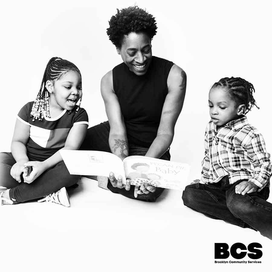 Jacqueline Woodson reading to two children